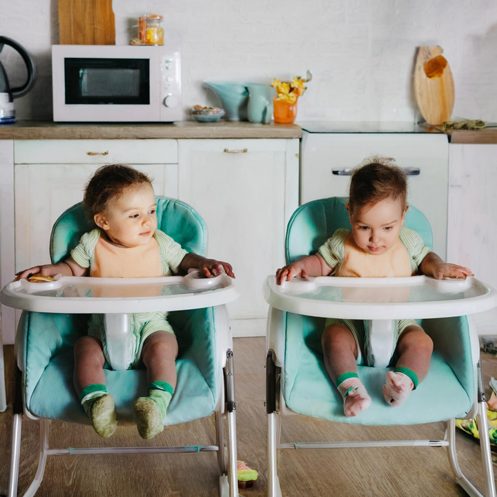 Identical twins in high chairs