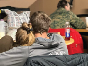 Man and woman hugging in a homeless shelter